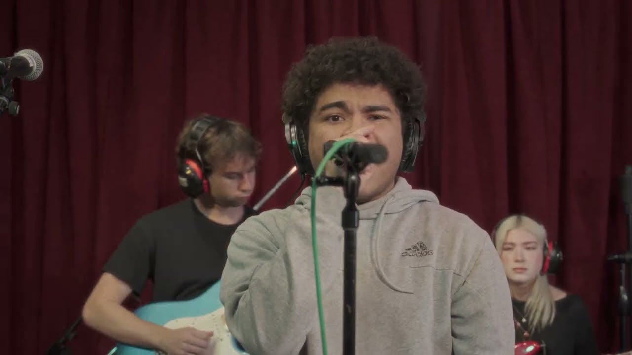 Francis singing into a studio microphone with his band during the 2026 setlist rehearsal film